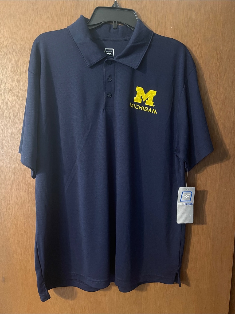 Pro Edge Navy Polo with Yellow Michigan Logo. Size XL